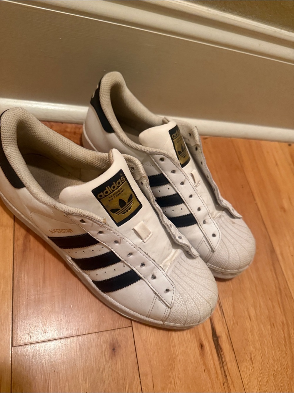 adidas Superstar women’s White Sneakers with Black Stripes and Gold Logo